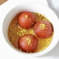 Gulab Jamoon · 2pcs,
fried cheese balls dipped in honey syrup.