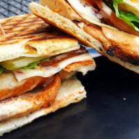 Buffalo Chicken Panini · Grilled buffalo chicken, melted pepperjack cheese, lettuce, and tomato. Served with a side o...