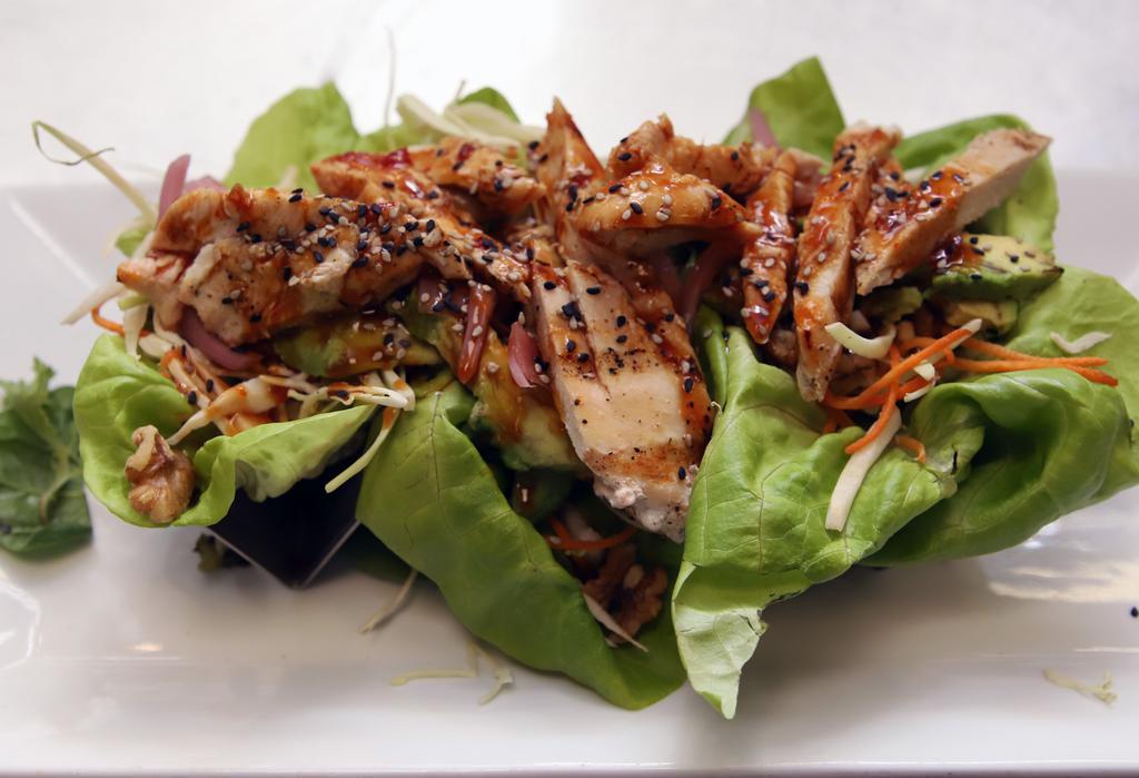 Trio Of Chicken Lettuce Wraps · Asian slaw/gochujang sauce/walnuts/avocado pickled red onions/sesame seeds.