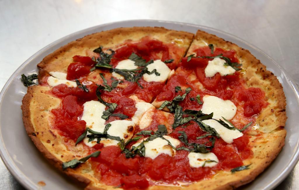 Margherita Flatbread · crushed tomato/fresh mozzarella/basil/ olive oil. Add cauliflower crust on request for an additional charge.