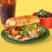 Tortas Combo · Served on a griddled telera roll with lettuce, jack cheese, vegetarian refried beans, red on...