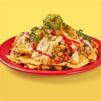 Nachos · Corn tortilla chips topped with melted jack cheese, black beans, roasted corn, red onion, gu...