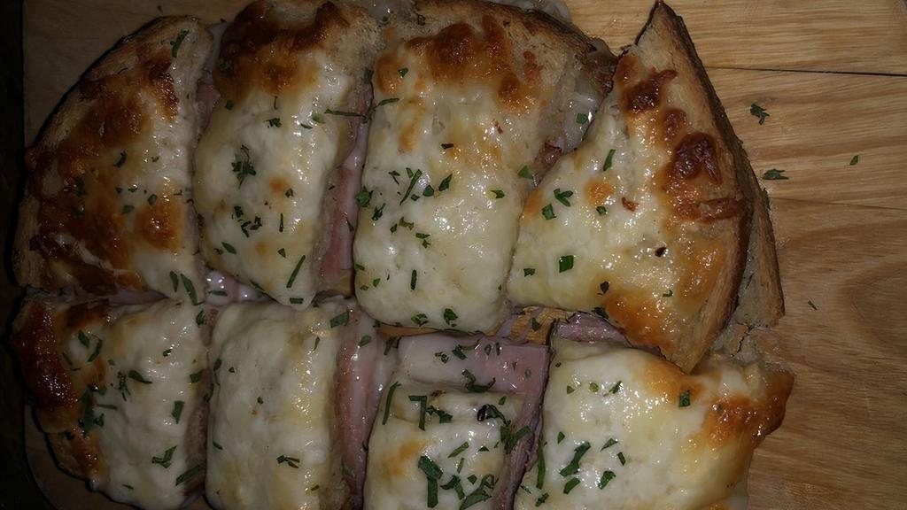 Croque Monsieur Bites · Ham and emmental cheese with bechamel on toasted brioche.