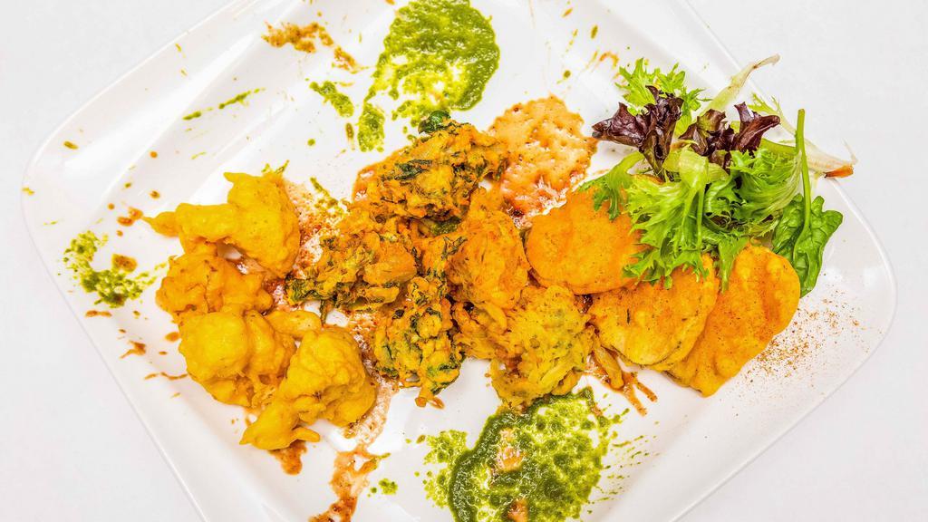 Veg Pakora · Vegetarian. Vegan. Must Try. Medium spiced vegetable fritters made with onion, potato, spinach, and cauliflower.