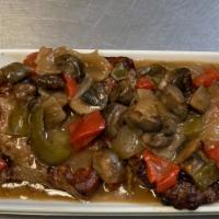 Solomillo · Filet Mignon bites sautéed with mushrooms, peppers, and red wine.
