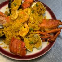 Paella Marinera · Saffron rice, clams, mussels, shrimps,  scallops and lobster.