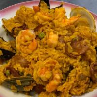 Paella Valenciana · Saffron rice, chicken, sausages, clams, mussels, and shrimps.