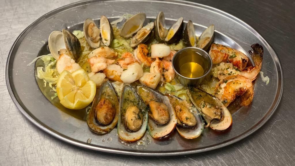 Parrillada De Mariscos · Broiled seafood combination (clams, mussels, shrimps, scallops, and lobster tails).