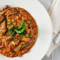 Cappellini Alla Miguel · With prosciutto, peas and mushrooms in a pink sauce.