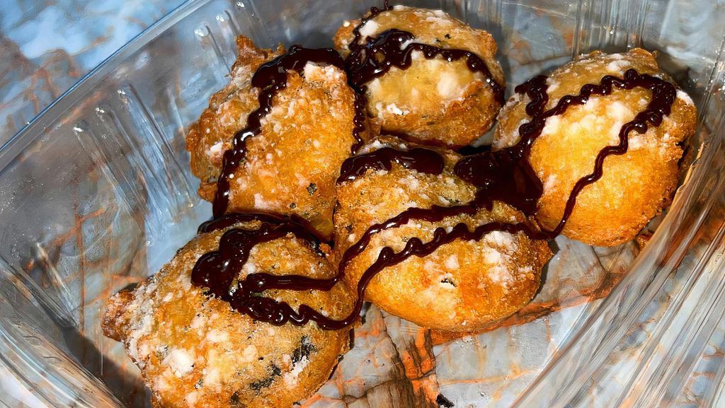 Classic Fried Oreos · 5 pieces of Original Oreos dipped in pancake batter & deep fried to golden brown perfection. Topped with powdered sugar & drizzled with chocolate syrup!