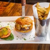 Narcisse Burger · Served with brioche bun, lettuce, tomatoes, cheddar cheese, and french fries.