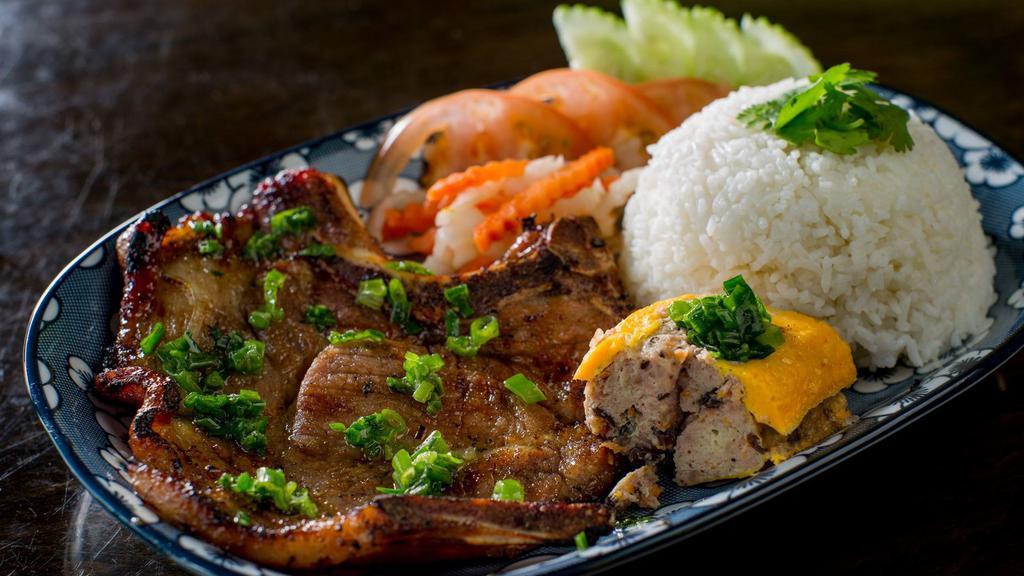 Com Suon Nuong · Grilled pork chop served with a ground pork and crab cake.