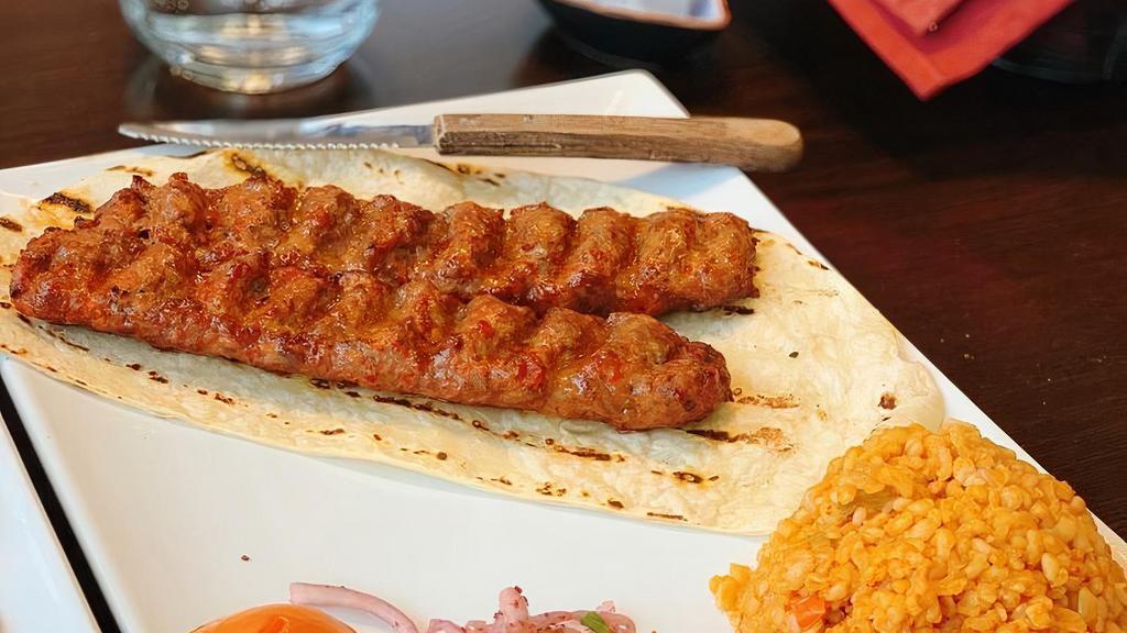 Adana Kebab · Skewered charcoal broiled ground lamb patties marinated with spices. Comes with your choice of side.