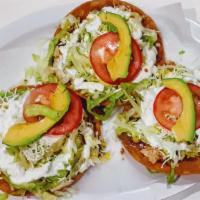 Tostadas · Three per order. Served with beans, cheese, cream, lettuce, avocado.