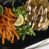 Falafel Over Rice · Served over brown basmati rice with a choice of seasoned fries and diced mixed salad or humm...