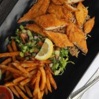 Fried Fish Over Rice · Fried Fish cut up. Served over brown basmati rice with a choice of seasoned fries and diced ...