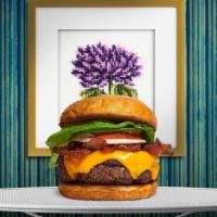 Strippin' Vegan Burger · Seasoned Beyond meat patty topped with melted vegan cheese, layers of crispy vegan bacon, le...