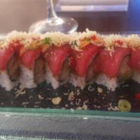 Izumi Roll · shrimp tempura and avocado inside topped with pepper tuna, crunchy and tobiko with eel sauce...