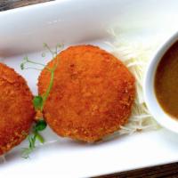 Curry Korokke · Fried mashed pumpkin stuffed with mozzarella or curry chicken. Served with curry sauce on th...