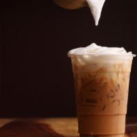 Iced Cappuccino · Freshly pulled shot of espresso with a small amount milk and a whole lot of foam over ice.