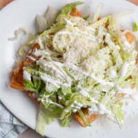 Flautas · Chicken, potatoes with Mexican pork sausage or steak served with lettuce, cheese, cream and ...