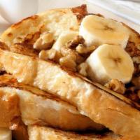 Banana French Toast · Warm french toast hot off the griddle, fresh bananas, dusted with powdered sugar and served ...