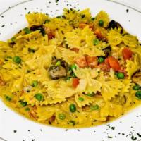 Cajun Pasta · Farfalle pasta sautéed with onions, tomatoes, mushrooms & peas in a cajun cream sauce