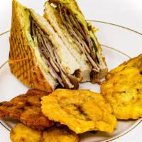 Cuban Panini · Roasted pork, sliced pickles, ham, swiss cheese & dijon
mayonnaise. Served with tostones