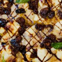 Gluten Free Vegan Pizza Medina · 10 inch square pan gluten free pizza topped with Turkish figs, balsamic reduction, sesame se...