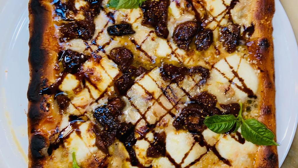 Gluten Free Vegan Pizza Medina · 10 inch square pan gluten free pizza topped with Turkish figs, balsamic reduction, sesame seeds and pleese cheese mozzarella.