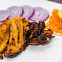Tandoori Chicken · Chicken with bone marinated for 48 hours, grilled in clay oven.