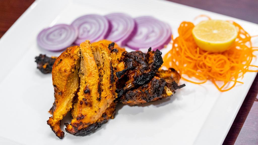 Tandoori Chicken · Chicken with bone marinated for 48 hours, grilled in clay oven.