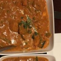 Rajasthani Lamb Curry · Marinated lamb simmered in a red chili curry sauce.