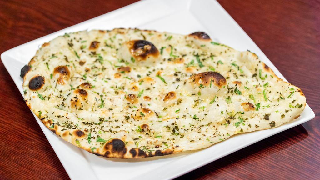 Garlic Naan · White flour bread topped with garlic and butter