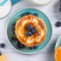Buttermilk Pancakes With Blueberries · Delicious Buttermilk pancakes, served hot off the griddle. Topped with fresh blueberries, bu...