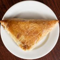 Spanakopita · Spinach and a touch of feta cheese baked in a flaky phyllo.