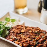 Fassoulia · Our famous and traditional red kidney beans, pan-fried with caramelized onions, scallions, g...