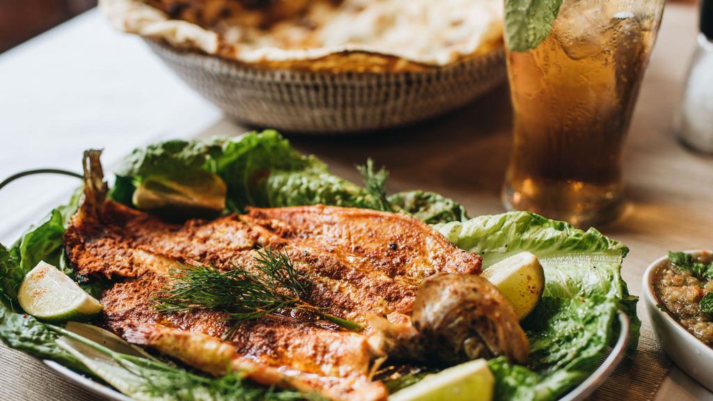 Trout · Grilled open boneless-trout, seasoned with hadramout's special spices. Served fresh tandoori rashoosh flat-bread.