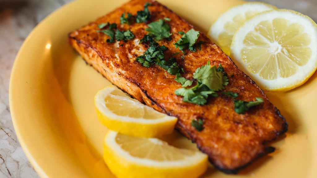 Salmon Fillet · Salmon fillet (boneless), seasoned with hadramout's special spices, and grilled oven. Served with a large fresh tandoori rashoosh flat-bread.
