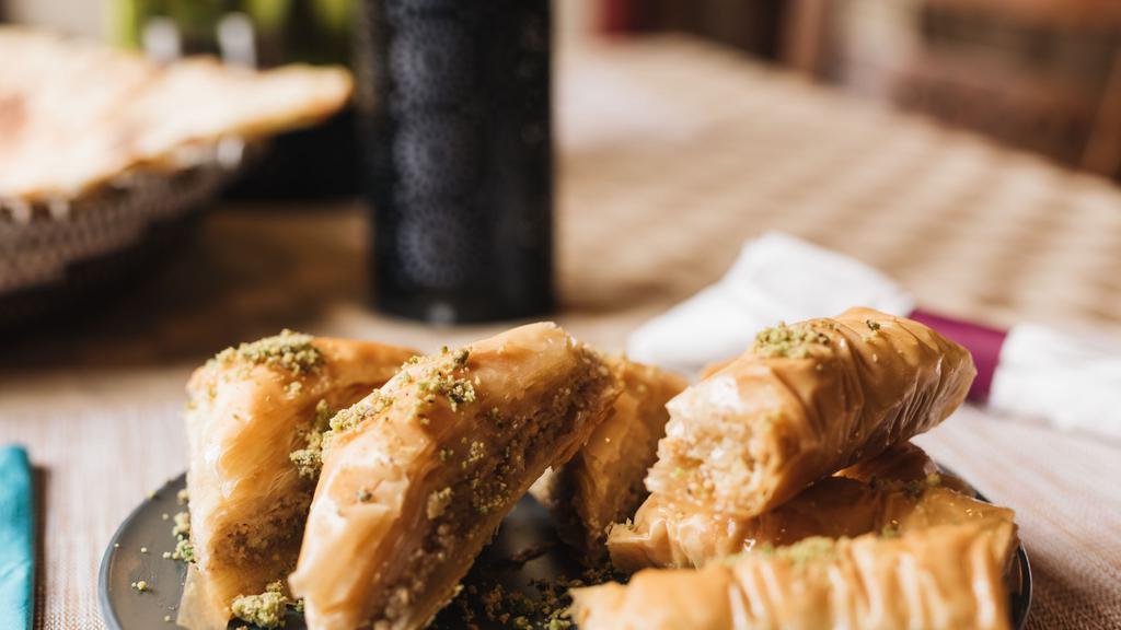 Baklawa · Sweet pastry made with extremely thin sheet of phyllo dough layered with chopped walnuts and honey syrup, topped with crushed pistachios.