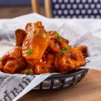 Buffalo Wings · Fresh batch of chicken wings topped with buffalo sauce.