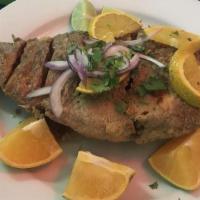 Filete De Pescado · Fish filet served with rice and beans, and tortillas or bread.