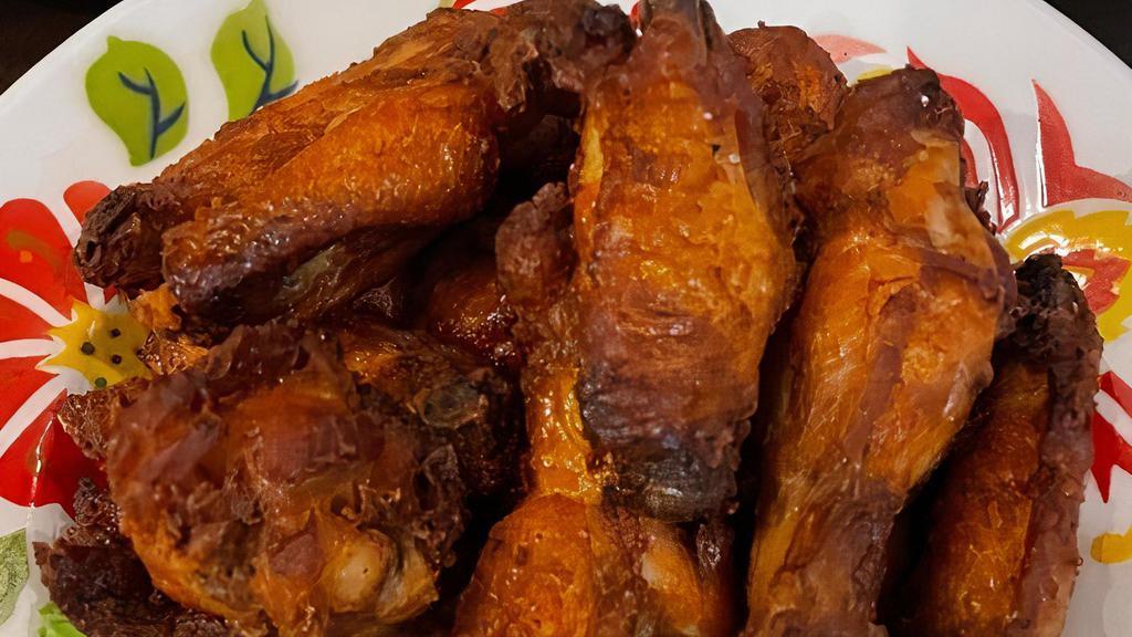 Peek Gai Yang Ka Min (Crispy Chicken Wings) · Deep-fried chicken wings marinated with sea salt, turmeric, garlic, fish sauce.