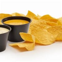 New! Dueling Queso & Chips · Best of both worlds! New queso blanco & signature gold queso with chips