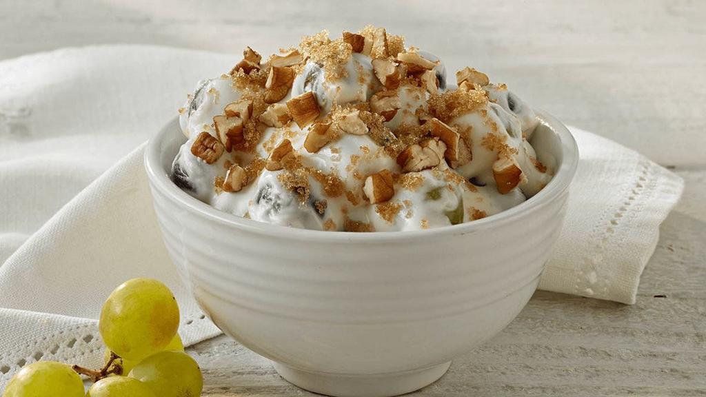 Grape Salad · Red & white seedless grapes covered in a sweet cream cheese mixture, topped with brown sugar & crushed pecans.