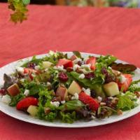 Seasonal Strawberry Side Salad · A bright summer salad topped with strawberries, sweetened dried cranberries, Fuji apples, fe...