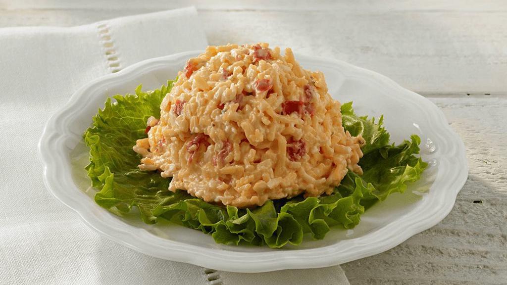 Spicy Pimento Cheese · A blend of freshly grated sharp cheddar & pepper jack cheeses combined with jalapenos & just a smidge of our creamy house dressing.