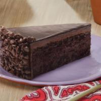 Divine Chocolate Cake Slice · Chocolate cake covered with chocolate icing then layered with fudge topping and chocolate ch...