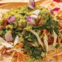 California Tacos · Two tacos filled with crispy chicken tenders, four cheese blend, cabbage, red onions, guacam...