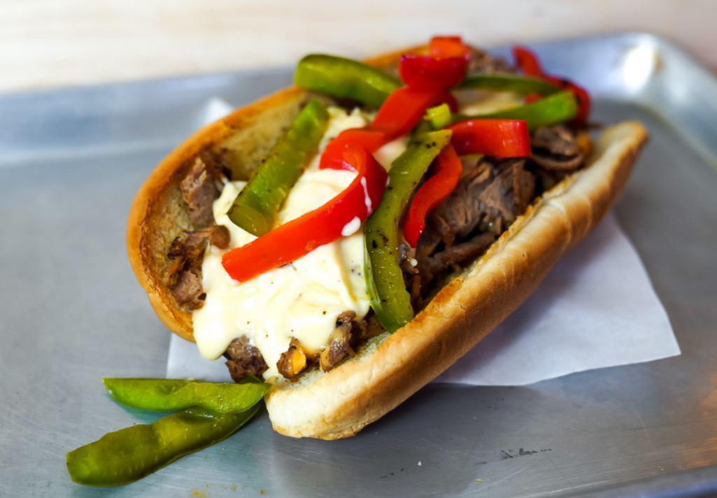 Grilled Pepper Cheesesteak · 8” Philly cheesesteak loaded with grilled steak, melted cheese, and grilled bell peppers on a toasted hoagie roll